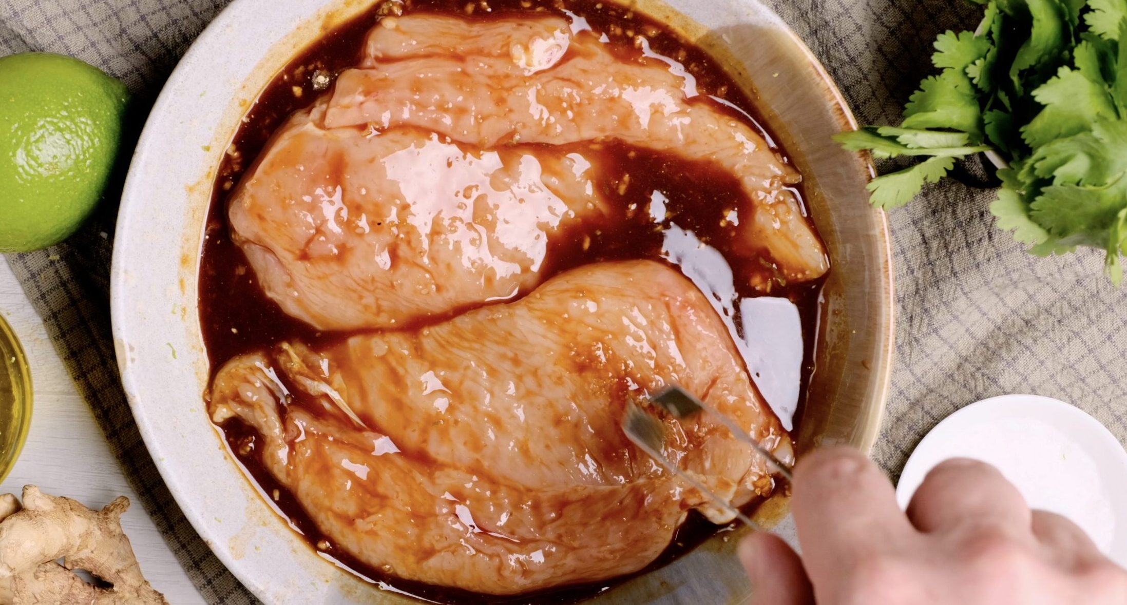 Grilled Chicken Breast being marinated in sauce