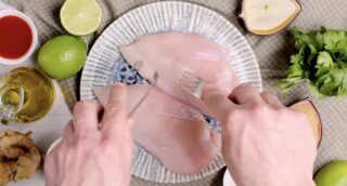 grilled chicken breast being pierced with fork