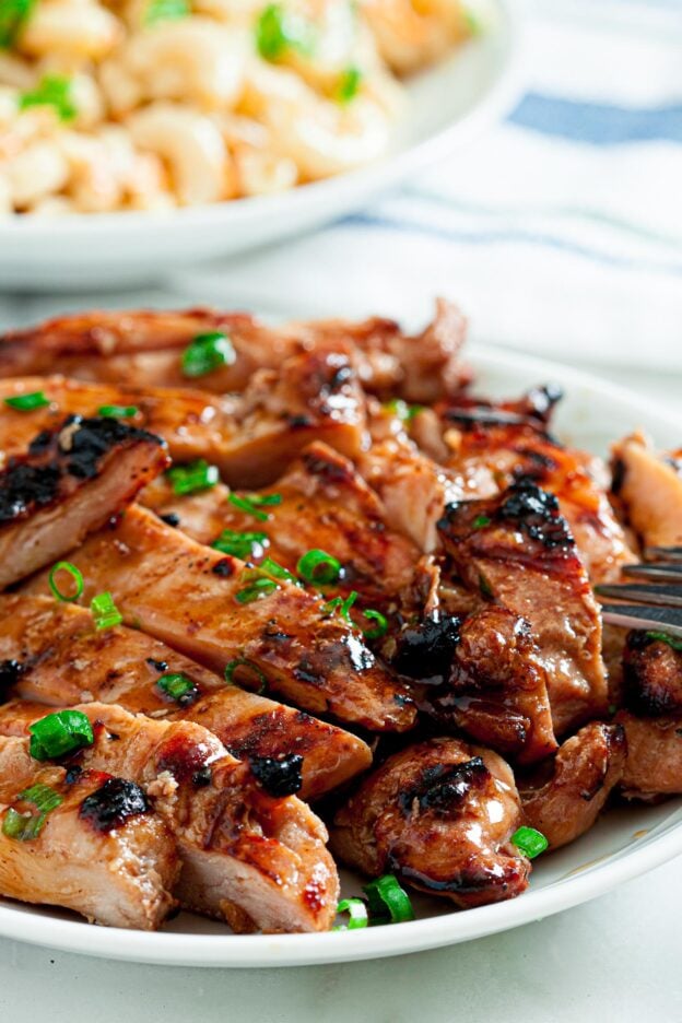 Grilled Chicken Thighs with Asian Marinade Sliced on white plate