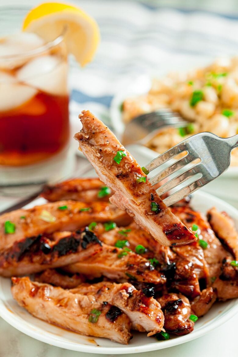 Grilled Chicken Thighs with Asian Marinade Sliced on white plate