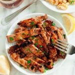 Grilled Chicken Thighs with Asian Marinade Sliced on white plate