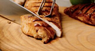 grilled chicken breast being sliced