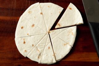 Uncooked flour tortilla cut into wedges