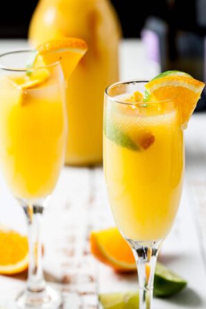 Mimosas with prosecco champagne and orange juice in flutes.