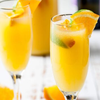 Mimosas with prosecco champagne and orange juice in flutes.