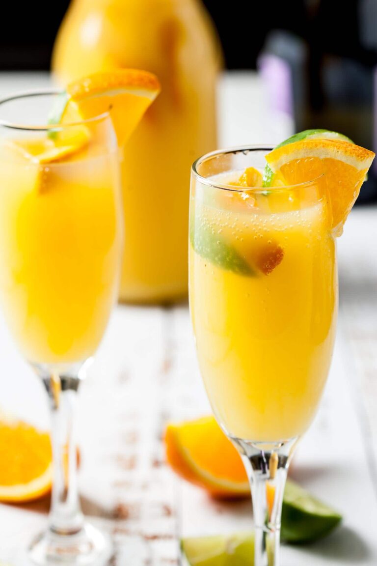 Mimosas with prosecco champagne and orange juice in flutes.