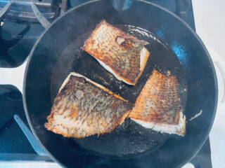 Barramundi filets cooking skin side up