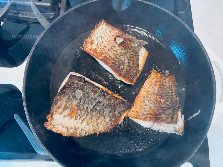 Barramundi filets cooking skin side up