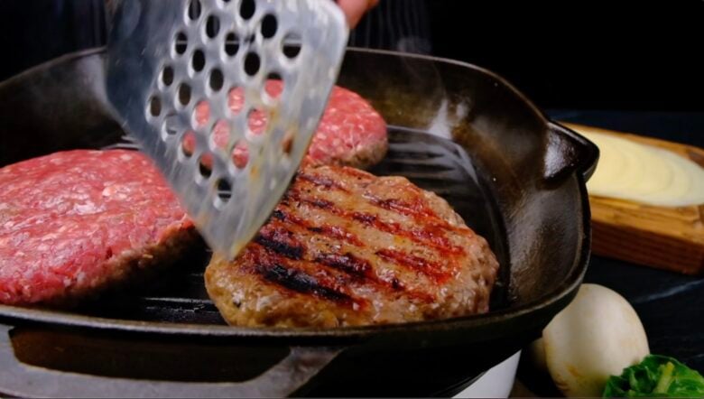 Ground beef patties cooking on a grill