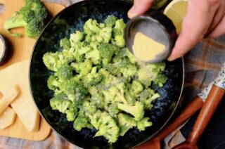 air fryer broccoli being seasoned
