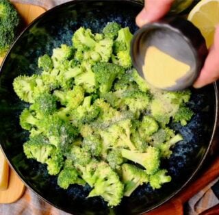 air fryer broccoli being seasoned