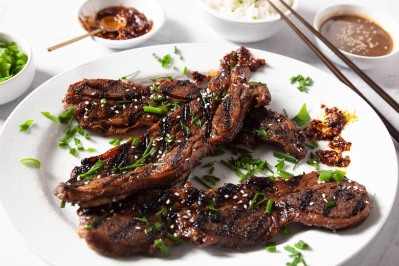 Kalbi beef short ribs on a plate with condiments