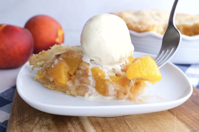 slice of peach pie with ice cream