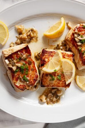 garnished halibut on plate vertical