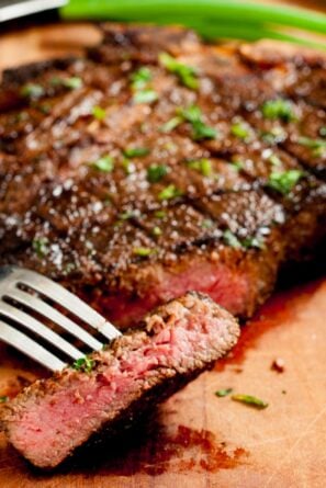 Grilled ribeye or t-bone steak on a cutting board