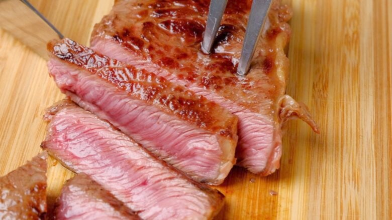 steak being cut for teriyaki.