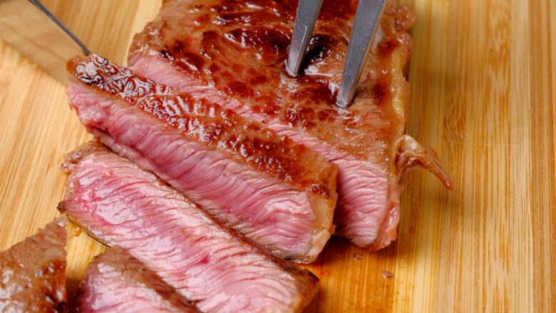 steak being cut for teriyaki.