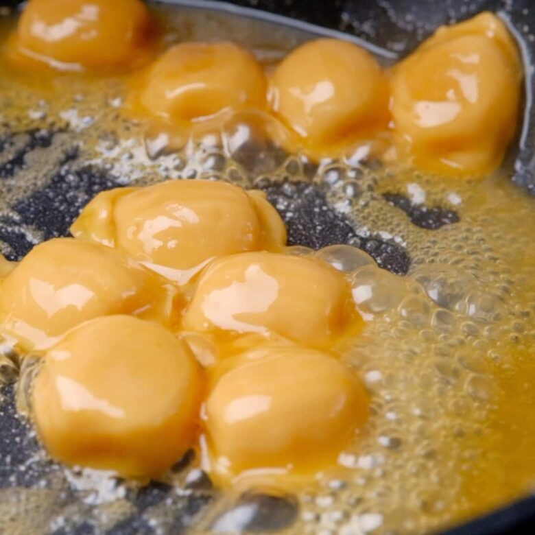 caramel candies being melted in a skillet