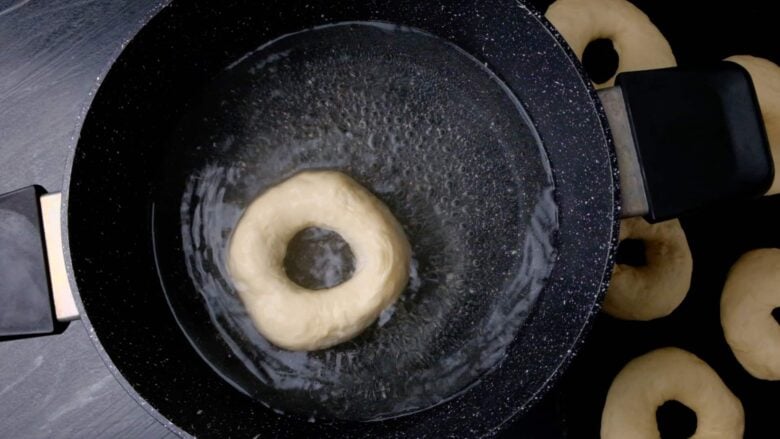 bagels boiling in a pot