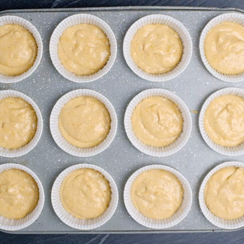 pumpkin cupcake batter divided evenly into muffin tins.