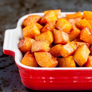 Roasted butternut squash in a red dish