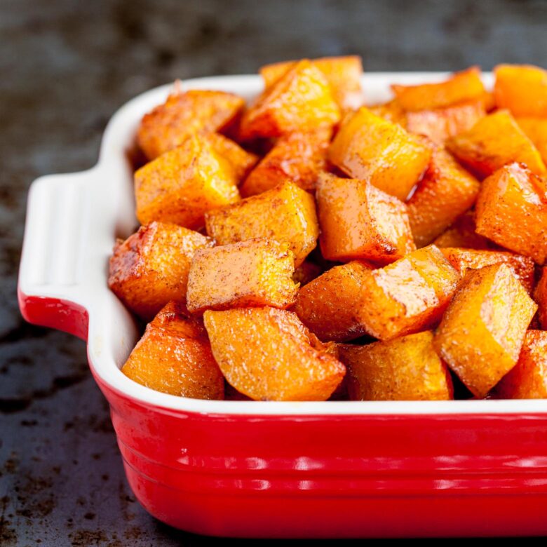 Roasted butternut squash in a red dish