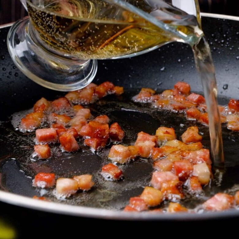 Bacon and Wine Simmering in Pan.