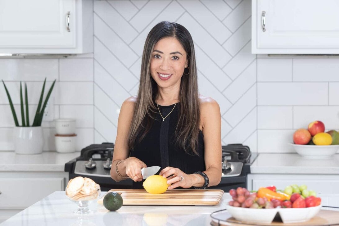 Amy Dong cutting vegetables in the kitchen