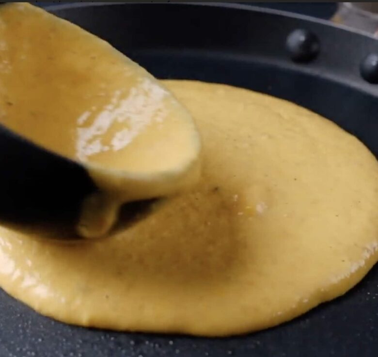 pumpkin pancakes poured into skillet.