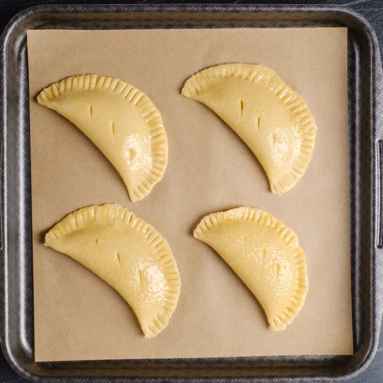 pumpkin pasties on baking tray.