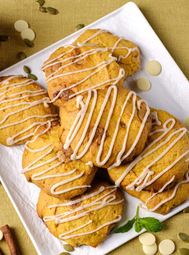 pumpkin spice cookies with glaze on a plate.