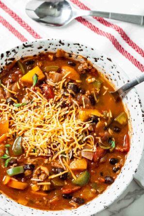 pumpkin chili with cheese in a bowl.