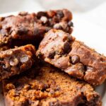 pumpkin chocolate chip bread sliced on plate.