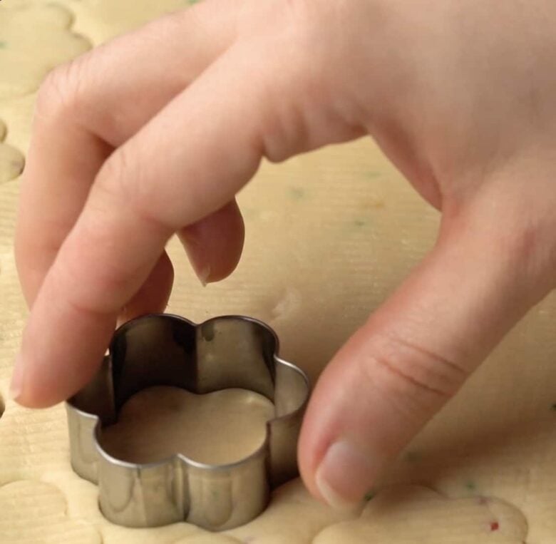 shortbread cookies dough being cut into shapes. 