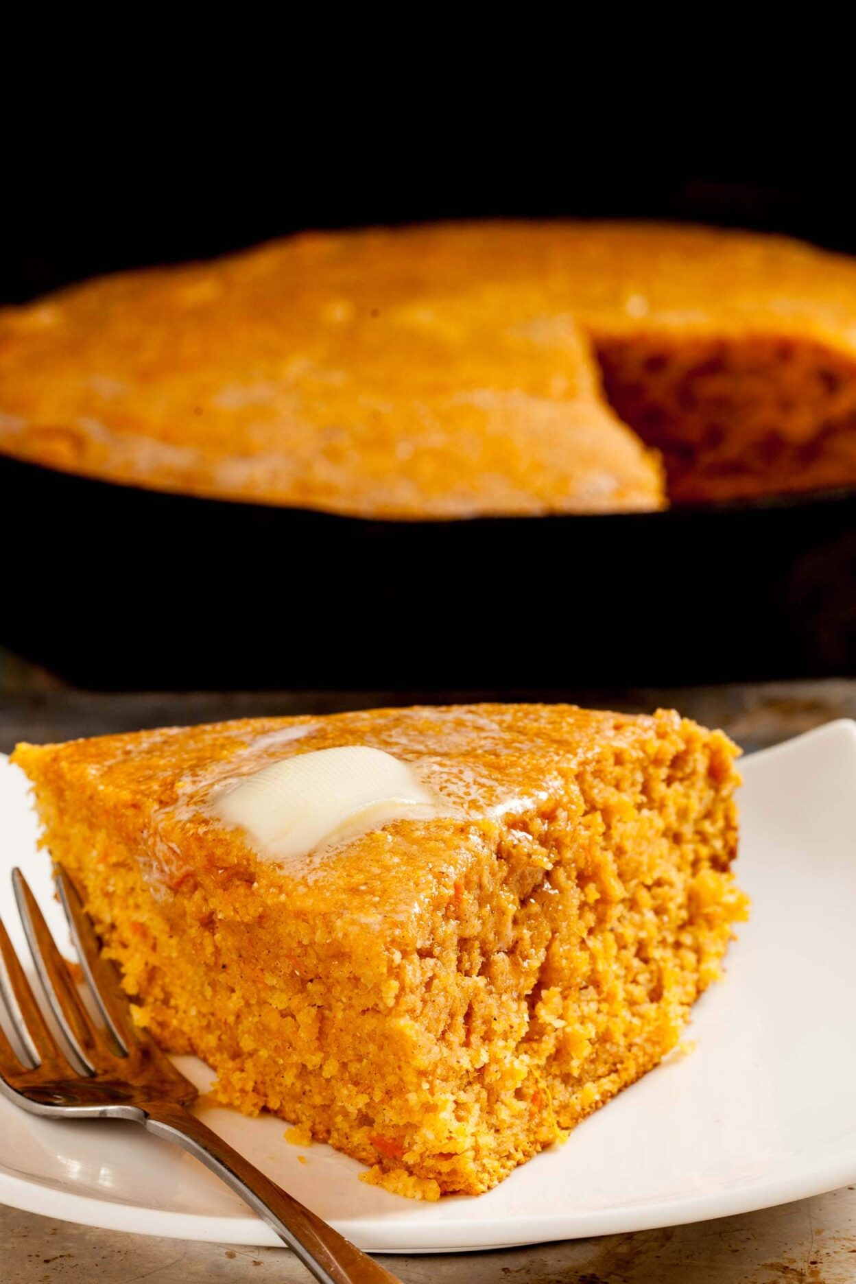 Slice of sweet potato cornbread with butter.