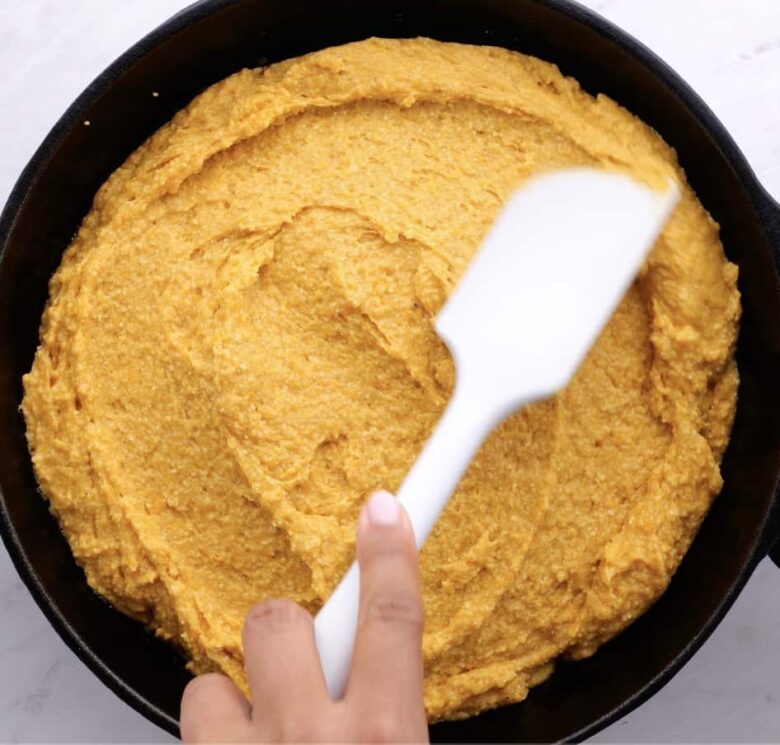 uncooked sweet potato cornbread in skillet.