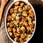 Apple sausage stuffing in a white dish.