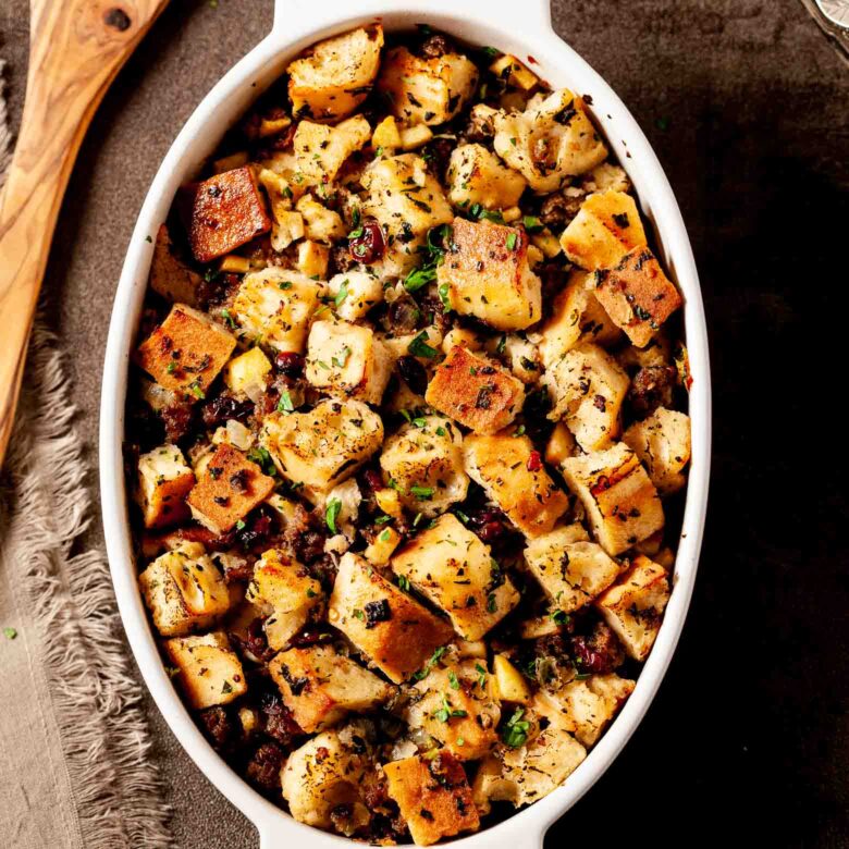 Apple sausage stuffing in a white dish. 