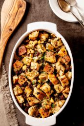 Apple sausage stuffing in a white baking dish.