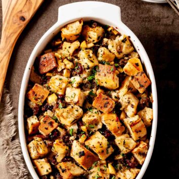 Apple sausage stuffing in a white baking dish.