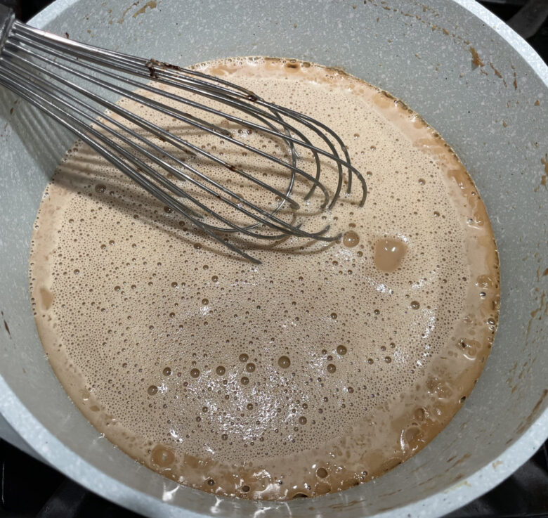 egg white and vanilla whisked together in a bowl for candied pecans.