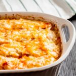 Cheesy Scalloped Potatoes in a white dish.