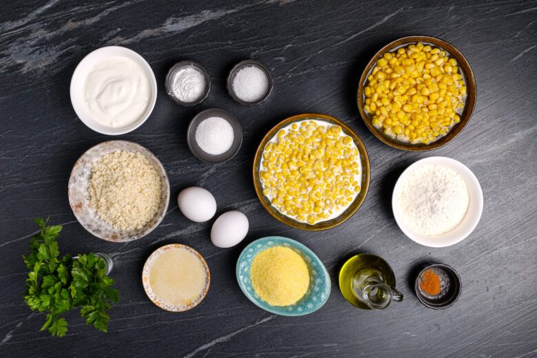 Overhead shot of easy corn casserole ingredients on a black table. 