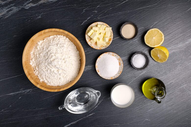 Overhead shot of easy dinner roll ingredients on a black table.