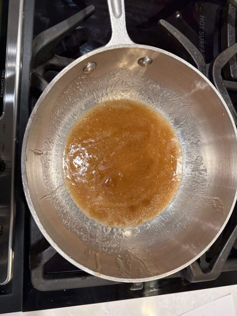 Pan with melted butter and ingredients for honey glazed carrots.