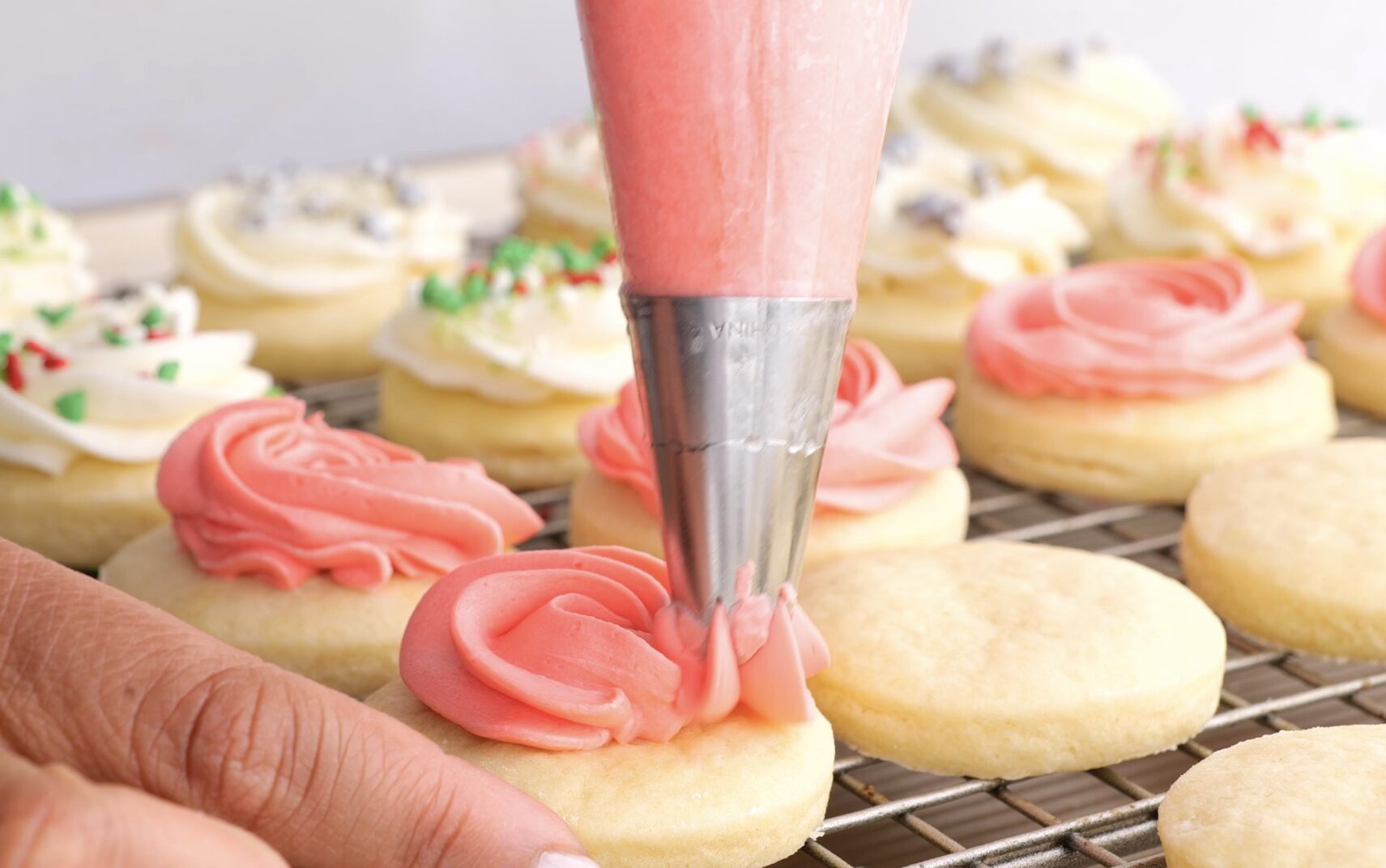 Lofthouse Cookies Being Frosted with buttercream frosting.