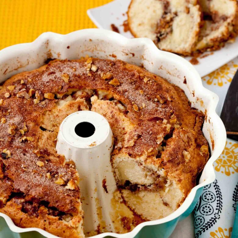 sour cream coffee cake sliced in Bundt pan.