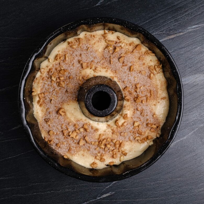 unbaked sour cream coffee cake in a Bundt pan.