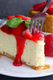 slice of strawberry cheesecake with a fork.