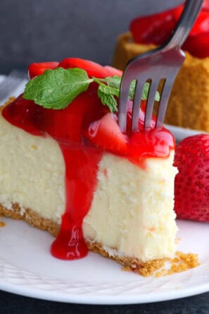 slice of strawberry cheesecake with a fork.